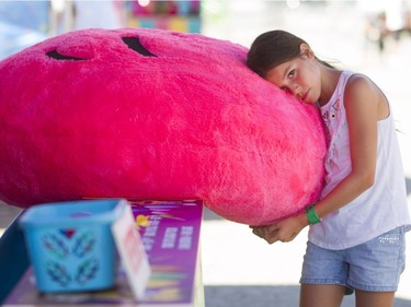 Ten-year-old Sakyah Diabo cuddles up to a prize that she wishes was hers, at the Capital Fair.