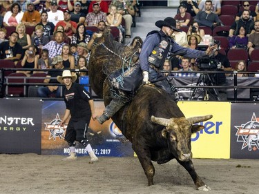 Texan Brant Atwood successfully rides Hillbilly Heaven in the championship round at the PBR bull riding competition at TD Place Arena Saturday night. Atwood won the event, taking home the top prize of $6,215.56. (Bruce Deachman, Ottawa Citizen)
