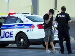 The Ottawa Police Service, including the guns and gangs unit, investigates a shooting on Merivale Road on Saturday, Aug. 6, 2016.
