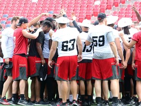 The Ottawa Redblacks gather for a big group huddle following an on-field walkthrough in advance of their upcoming game against Montreal Thursday in Montreal.
