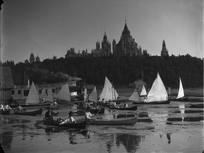 Canoes, some with sails, and steamboats on the sawdust-choked Ottawa River in July 1889, just downstream of the Chaudiere Falls sawmills.