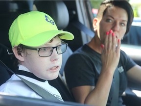 Tina Boileau blows a kiss to her family as she and her son Jonathan Pitre leave the driveway of their Russell home Wednesday for a bone marrow transplant operation in Minnesota.