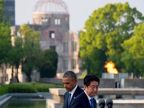 Japanese Prime Minister Shinzo Abe (R), alongside U.S. President Barack Obama, placed wreaths during a visit to the Hiroshima Peace Memorial Park in Hiroshima in May, 2016.