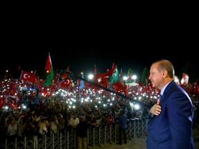 Turkish President Recep Tayyip Erdogan addresses  people gathered at the Presidential Complex to protest the July 15th failed military coup attempt  in Ankara, Turkey on August 10, 2016.  /