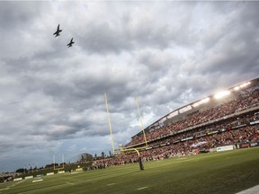 Two CF-18 Hornets perform a flypass over TD Place at the start of the Ottawa Redblacks game against the BC Lions on Canadian Forces Appreciation Night.