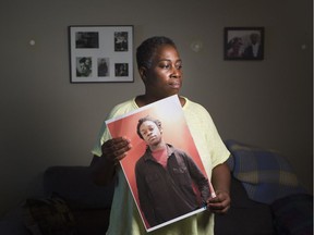 Maureen Henry holds a photograph of her son, Dovi, who was found dead and without ID in Lake Ontario near Ontario Place in July 2014.