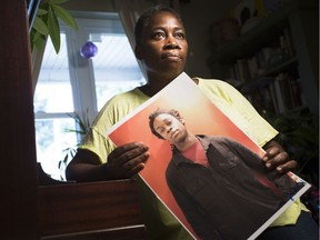 Maureen Henry holds a photograph of her son, Dovi, who was found dead and without ID in Lake Ontario near Ontario Place in July 2014, in her house in Ottawa Wednesday, September 7, 2016.