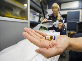 VANCOUVER September 01 2016. BC Ambulance Service primary care paramedics Jill ( L ) and Stefan (R) display the ventilation bag with airways and the Naloxone and needle that are used to reverse the effects of an fentanyl overdose, Vancouver, September 01 2016.  ( Gerry Kahrmann  /  PNG staff photo)  ( Prov / Sun News )