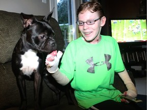 Jonathan Pitre plays with his dog, Gibson.