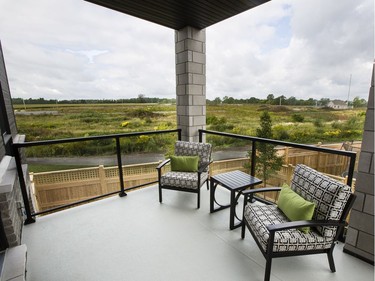 Kitchen deck: The main level living space extends to a roomy deck off the kitchen, where glass-panelled railings don’t impede the view of the creek.