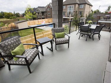 Kitchen deck: The main level living space extends to a roomy deck off the kitchen, where glass-panelled railings don’t impede the view of the creek.