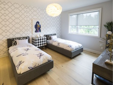 Second girl’s room (two beds): Like all the other bedrooms, the second girl’s room (or maybe it’s for twins?) includes a feature wall in geometric wallpaper.