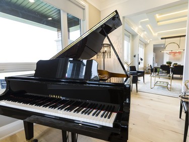 Piano room: A den off the foyer lost its walls, creating the perfect home for a grand piano. ‘The home office really is moving away from being a special room that you go to where your desktop is all hooked up,’ says designer Donna Correy. ‘People are using their iPads, their tablets, their iPhones. They want to be able to use them anywhere.’ Changing the room’s function creates a ‘wow’ and speaks to a modern open-concept interior as soon as you walk in the front door.