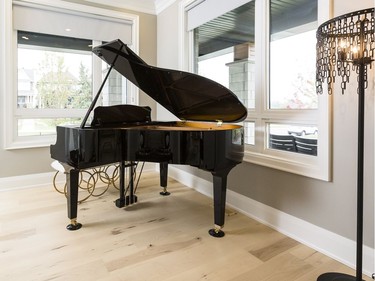 Piano room: A den off the foyer lost its walls, creating the perfect home for a grand piano. ‘The home office really is moving away from being a special room that you go to where your desktop is all hooked up,’ says designer Donna Correy. ‘People are using their iPads, their tablets, their iPhones. They want to be able to use them anywhere.’ Changing the room’s function creates a ‘wow’ and speaks to a modern open-concept interior as soon as you walk in the front door.