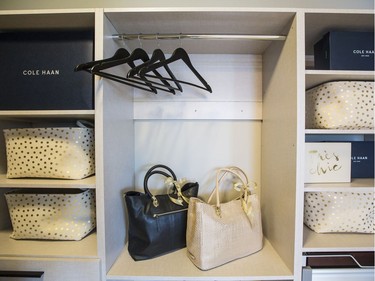 Master walk-in: The master walk-in closet includes two handbags donated by Cole Haan. Custom built-in shelving provides plenty of storage space.