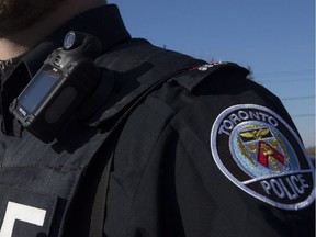 A Toronto Police Officer poses for a photo wearing a body camera as part of his equipment while on duty in Toronto on November 25, 2015.