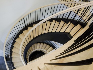 Staircase: A key feature is the curved staircase that spans all three floors. Pulled away from the wall and with open risers and oak treads supported by matte black stringers mimicking a wrought iron look, it provides a sculptural effect in the centre of the home. ‘For me, the staircase is always a pretty big feature in the dream homes,’ says designer Donna Correy. ‘If it can become a great feature, it’s one of the first ones I look to, to dressing up.’ Dressing this one up meant rearranging the mud room and back hall to create enough space for it.
