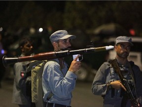 This 2016 photo shows an Afghan policeman holding a rocket-propelled grenade launcher as he responds to a Taliban attack on the campus of the American University in the Afghan capital Kabul.