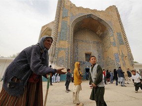 An Afghan woman begs for alms in front of the shrine of Khoja Abu Nasr Parsa on the ruins of the ancient city of Balkh, located outside the northern Afghan town of Mazar-i-Sharif, on March 22, 2009. Once known as the "mother of cities," the ancient city of Balkh was a popular destination along the ancient Silk Route. Balkh was destroyed by Mongol conquerer Genghis Khan during his rule, with the city's ruins remaining as a tourist attraction today.