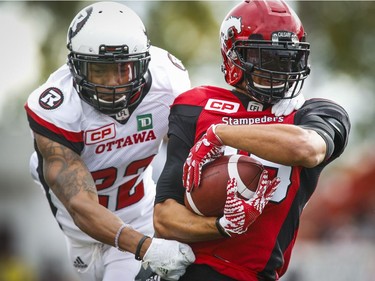 Ottawa Redblacks' Jeff Richards, hauls down Calgary Stampeders' Anthony Parker during first half CFL football action in Calgary, Saturday, Sept. 17, 2016.