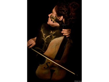 Artist May Mutter created this violin painting on Mary Baumer. Both women have suffered serious concussions. (Kelly Hotte Photography)