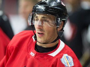 Brad Marchand looks on from the boards as Team Canada practices at Canadian Tire Centre in preparation for the World Cup of Hockey Tournament.