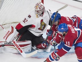 Ottawa Senators goaltender Chris Driedger makes a save as Montreal Canadiens' Brendan Gallagher (11) and Alex Galchenyuk (27) look for the rebound during first period NHL pre-season hockey action in Montreal, Thursday, September 29, 2016.