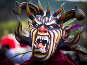 Brian Pomares is dressed as Diablico Sucio — "Dirty Devil" — during the Latin American Festival parade on Sunday.