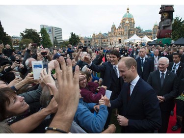 Prince William The Duke of Cambridge (R), and Canadian Prime Minister Justin Trudeau (2R) greet onlookers in front of the Legislative Assembly in Victoria, British Columbia on September 24, 2016. The prince and his wife first visited Canada five years ago. This time they will take in the natural beauty of Canada's Pacific coast, heading as far north as the rugged Yukon territory, and will also meet with indigenous people. /