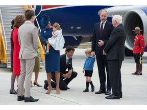 Prime Minister Justin Trudeau kneels to talk to Prince George.