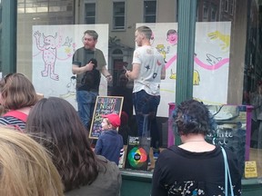 Canadian children's books illustrator Sydney Smith (in the white T-shirt) collaborates on a two-panel drawing with his Irish counterpart, Chris Judge (in the black T-shirt) in the window of the Hodges Figgis bookshop in downtown Dublin, on the eve of the 2016 Children's Books Ireland conference.