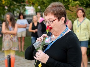 Catherine Cameron kisses a rose before dropping it in the Mississippi River in honour of her late husband, Mississippi Mills Coun. Bernard Cameron, who was shot and killed last February trying to defend their daughter against her estranged partner, who then took his own life.