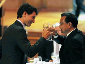 Chinese Premier Li Keqiang, right, and Canadian Prime Minister Justin Trudeau share a toast at a dinner hosted by Trudeau in the Chinese Premier's honour in Gatineau, Quebec on Thursday, September 22, 2016. THE CANADIAN PRESS/Fred Chartrand ORG XMIT: FXC118