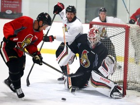 Clarke MacArthur (L) of the Ottawa Senators can't score on Chris Driedger during the first day of training camp at the Bell Sensplex.