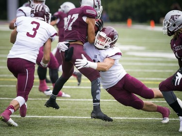 Cole Munden of the Marauders tackles Gee-Gees player Kalem Beaver.