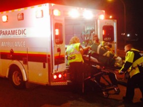 Paramedics load a victim into an ambulance following a crash late Tuesday.