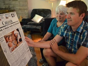 David Mountain and his mother, Margaret Mountain, look at a picture of David sitting on his father's lap when Mother Teresa visited Ottawa in 1988.