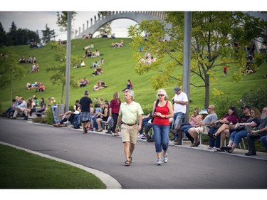 Early festival-goers relax and take in the music on the great lawn at Lansdowne Park on Sunday, Sept. 18, 2016.