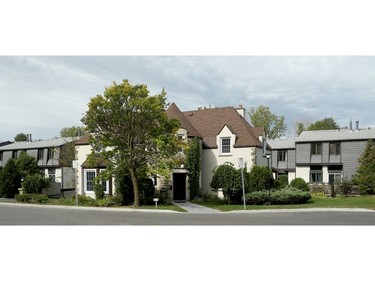 - Exterior of home, surrounded by newer townhouse.