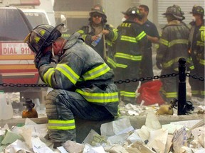 A firefighter breaks down after the World Trade Center buildings collapsed September 11, 2001 after two hijacked airplanes slammed into the twin towers in a terrorist attack.