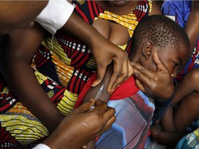 This July 21, 2016 file photo shows residents of the Kisenso district receiving yellow fever vaccines in Kinshasa, Democratic Republic of Congo.