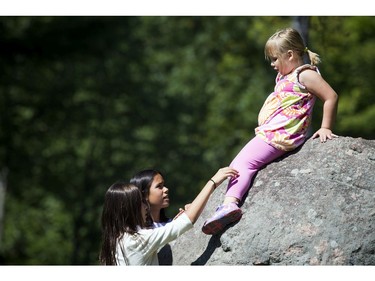 Kylie Lee, 5, climbed up on a big rock and needed just a little help down at Kingsmere.