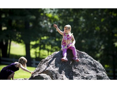 Five-year-old Kylie Lee climbed up on a big rock at Kingsmere in Gatineau Park.