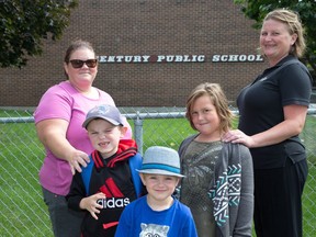 From left, Gemma Nicholson, with kids  Liam, in Grade 2, age 7, and Jack, in SK, age 5, Karen Vandenham and daughter Leila, Grade 2, age 7. They love Century Public School, but the parents say they understand why the school board staff recommend it be closed.