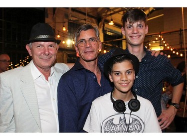 From left, Peter Honeywell, executive director of the Ottawa Council for the Arts, with Clayton Kennedy and his sons, Adam, 12, and Teagan, 17, during a party thrown by Kennedy's wife, prominent businesswoman Sheila Whyte, to celebrate the 25th anniversary of Thyme & Again Creative Catering and Take Home Food Shop. (Caroline Phillips / Ottawa Citizen)