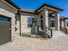 This four-bedroom home at 6211 Pebblewoods Dr. features a finished basement with theatre, bar, gym, recreation room and playroom.