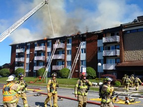 Ottawa firefighters assist at the scene of a major fire in Gatineau Thursday.