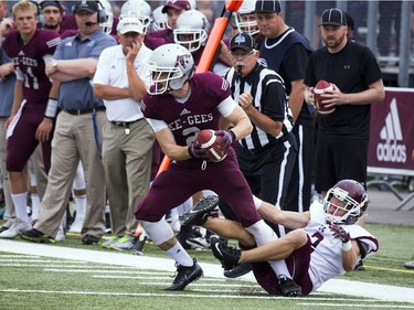 The Gee-Gees' Mitchell Baines tries to get away from Robbie Yochim of the Marauders.
