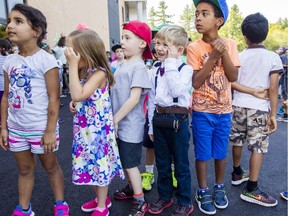 Grade one students at the brand new Kanata Highlands Public School, including Rhys Fisher, in suspenders and bow-tie, line up after recess on the first day of school Tuesday, Sept. 6, 2016.