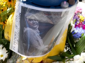 A growing memorial for Nusrat Jahan, the 23-year-old cyclist who died in a collision on Lyon Street Thursday morning in Ottawa. People passing the memorial Friday Sept 2, 2016.